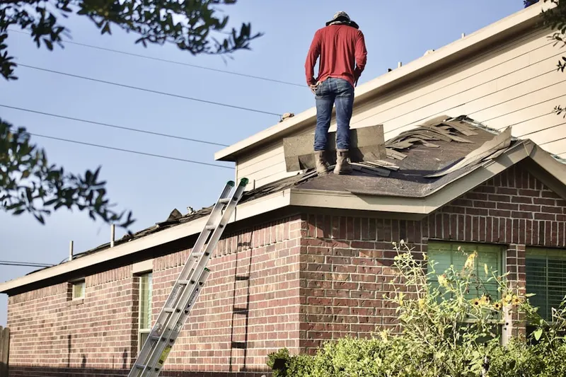 Professional roofer working on a residential roof in Honeygo